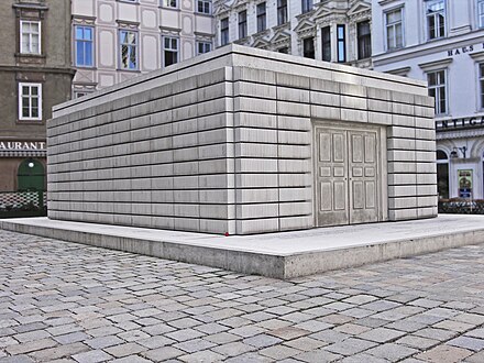 Library books arranged with their spines inwards. The sculpture represents 65k Jews murdered in the Holocaust. Because the spines face inwards you cannot read their stories.