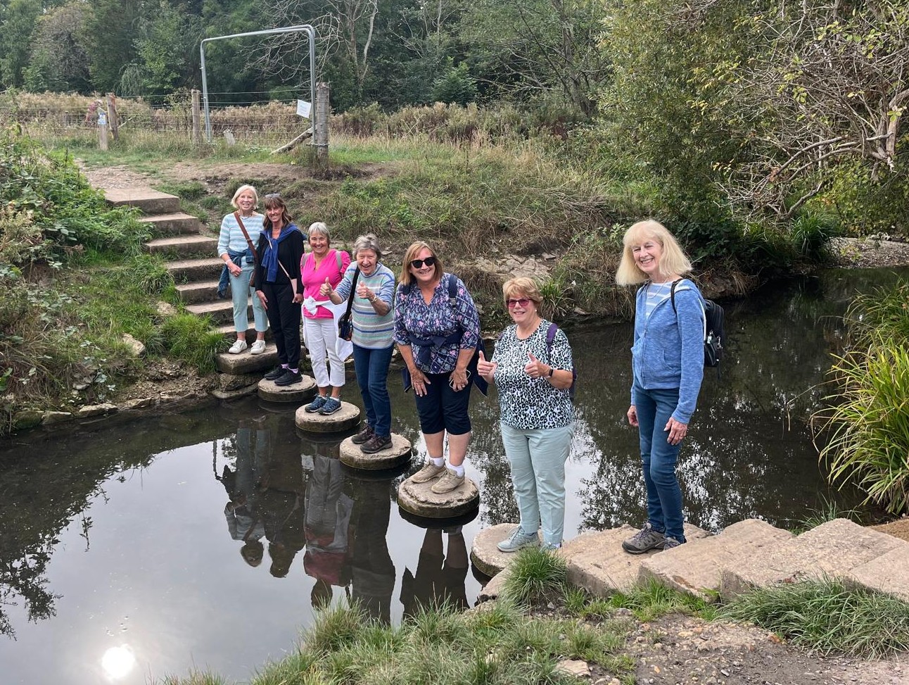 Bookham walking group on stepping stones across the Hogsmill